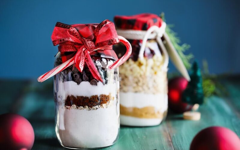 two jars of homemade food gifts for christmas with bows on top