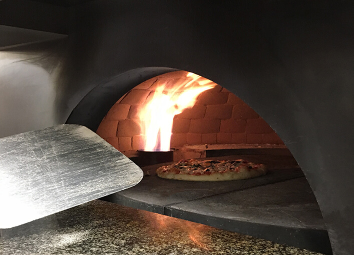 https://www.skh.com/wp-content/uploads/2021/06/Flame-Cooking-Brick-Oven-Pizza.jpg