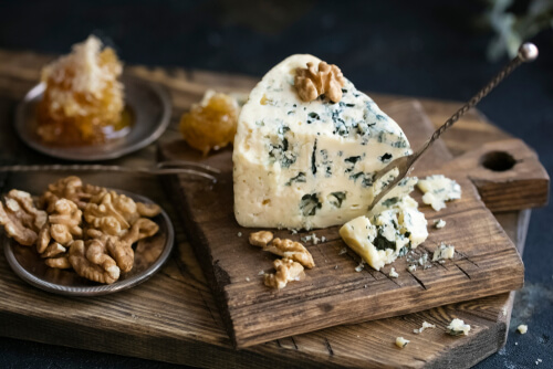 wedge of blue cheese on a cutting board